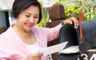 Senior woman opening a direct mail piece.