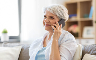 Image of a senior purchasing insurance from an agent over the phone.