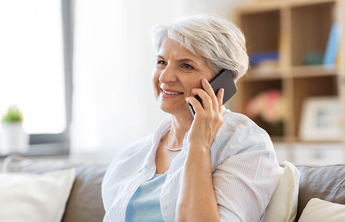 Image of a senior purchasing insurance from an agent over the phone.