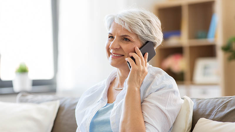 Image of a senior purchasing insurance from an agent over the phone.