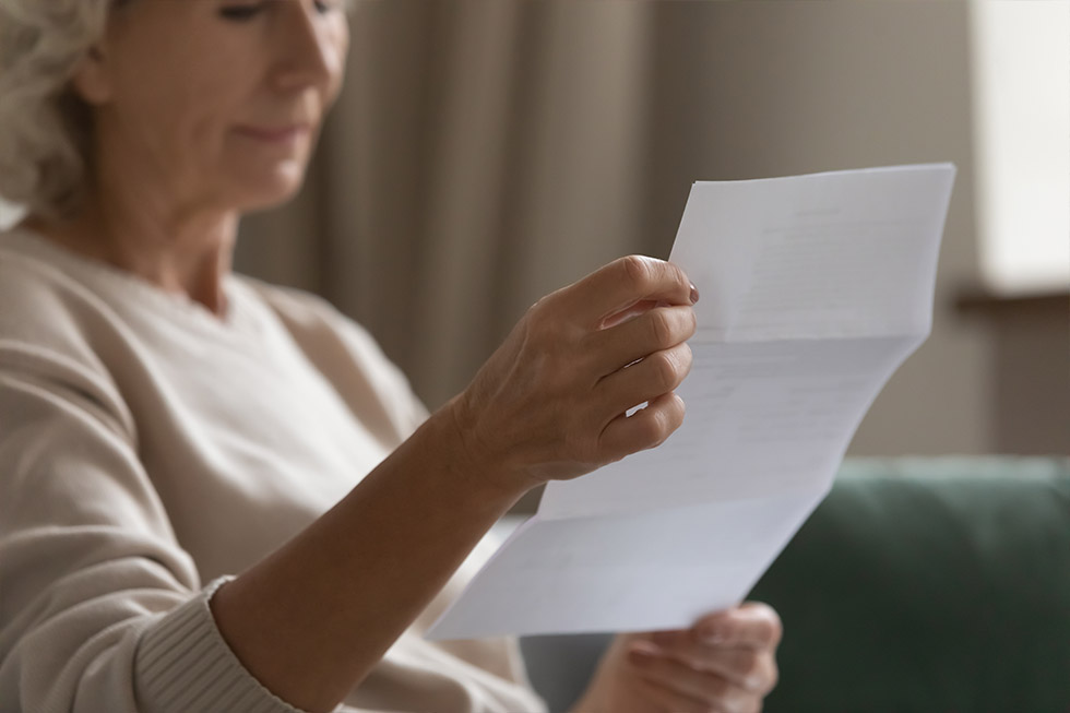 An image of a senior reading a direct mail piece.
