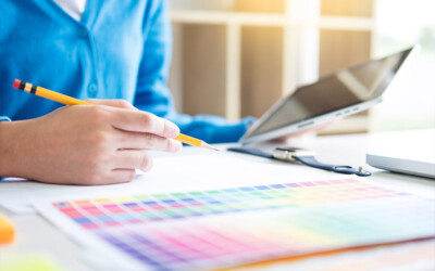 An insurance agent reviewing color options for a direct mail advertisement.