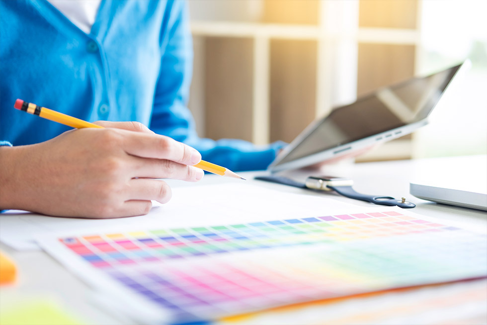 An insurance agent reviewing color options for a direct mail advertisement.