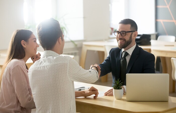 Insurance agent closing a sale with a potential client.