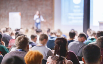 An image of an insurance agent presenting to an audiance.