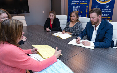 Group of Lead Concepts Employees discussing direct mail lead generation.