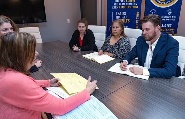 Group of Lead Concepts Employees discussing direct mail lead generation.