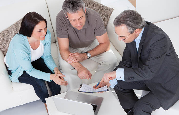 Mortgage protection agent discussing policies with clients.