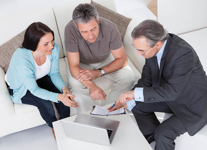Mortgage protection agent discussing policies with clients.