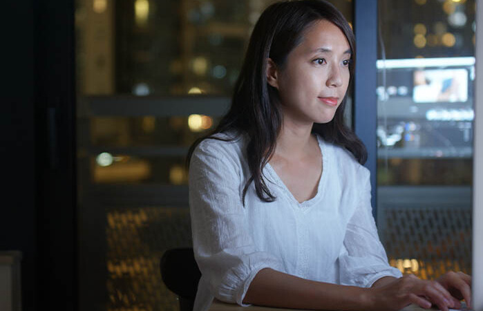 Female insurance agent exploring lead generation options on her computer.