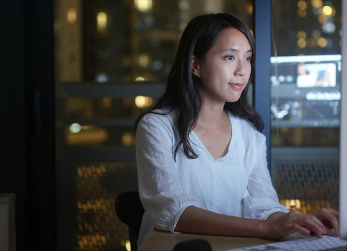 Female insurance agent exploring lead generation options on her computer.