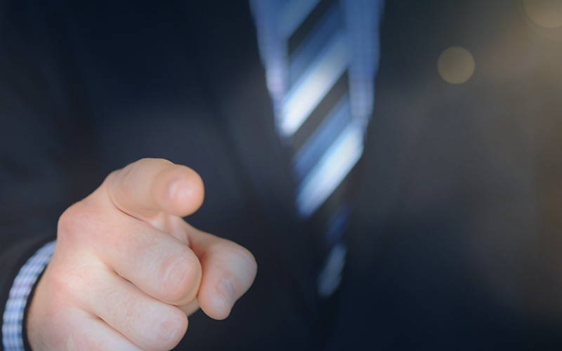 an image of an insurance agent looking to recruiting other insurance agent pointing.
