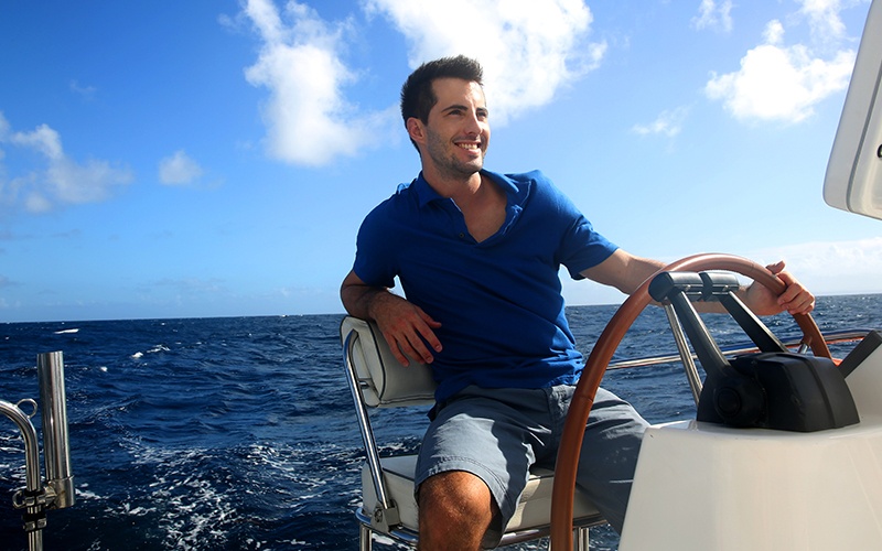 Image of a man sailing a boat on the ocean.