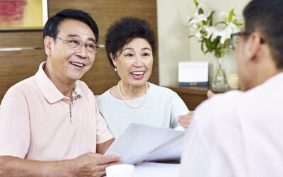 Insurance agent meeting with a husband and wife during the AEP season.
