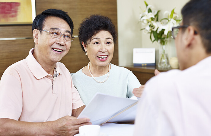 Insurance agent meeting with a husband and wife during the AEP season.