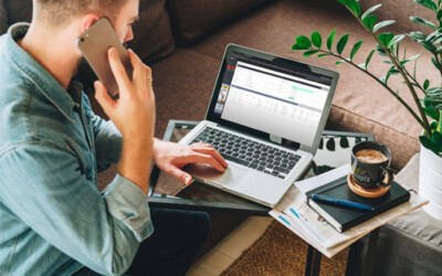 An image of an insurance agent on the phone and working on rebranding and repurposing his insurance agency.