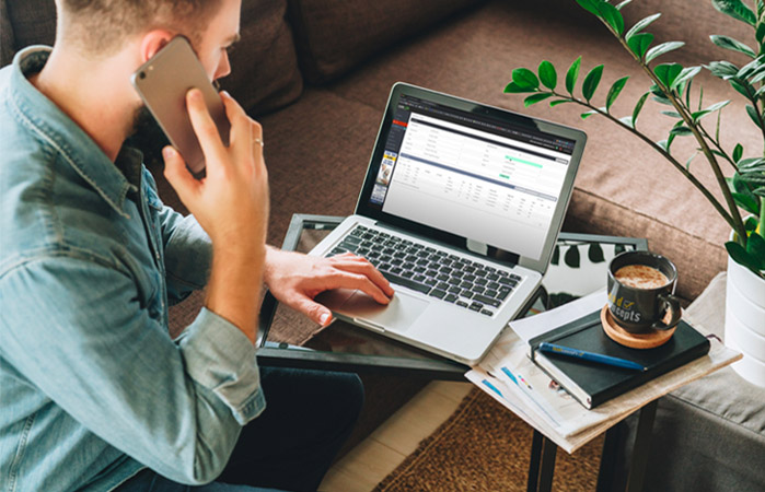 An image of an insurance agent on the phone and working on rebranding and repurposing his insurance agency.