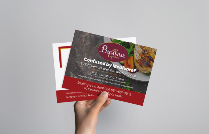 Image of a hand holding two seminar marketing mailers.