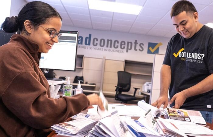 Two Lead Concepts employees organizing exclusive leads.