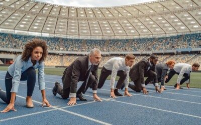 A group of insurance marketing professionals getting ready to run a race on a track.